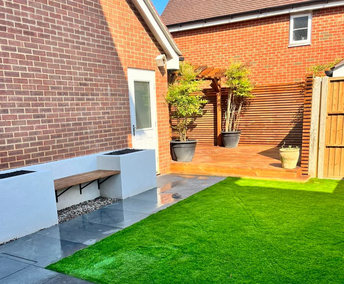 Full garden landscaping with artificial grass, patio and pergola in Broadbridge Heath