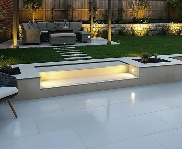Supplied project photograph of porcelain paving, illuminated steps and planters